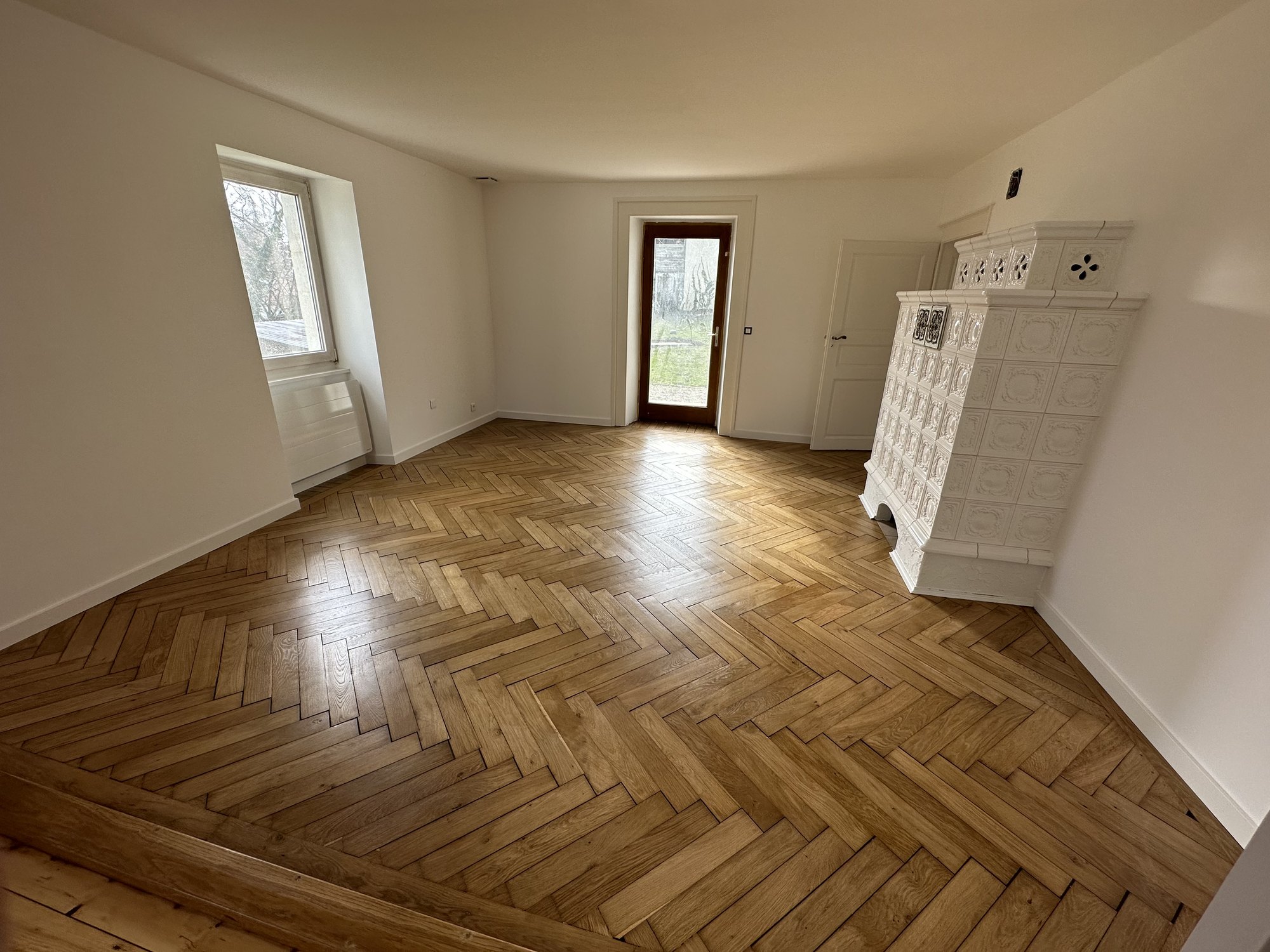 Parquet point de Hongrie avec poêle en faïence sur un chantier KGK