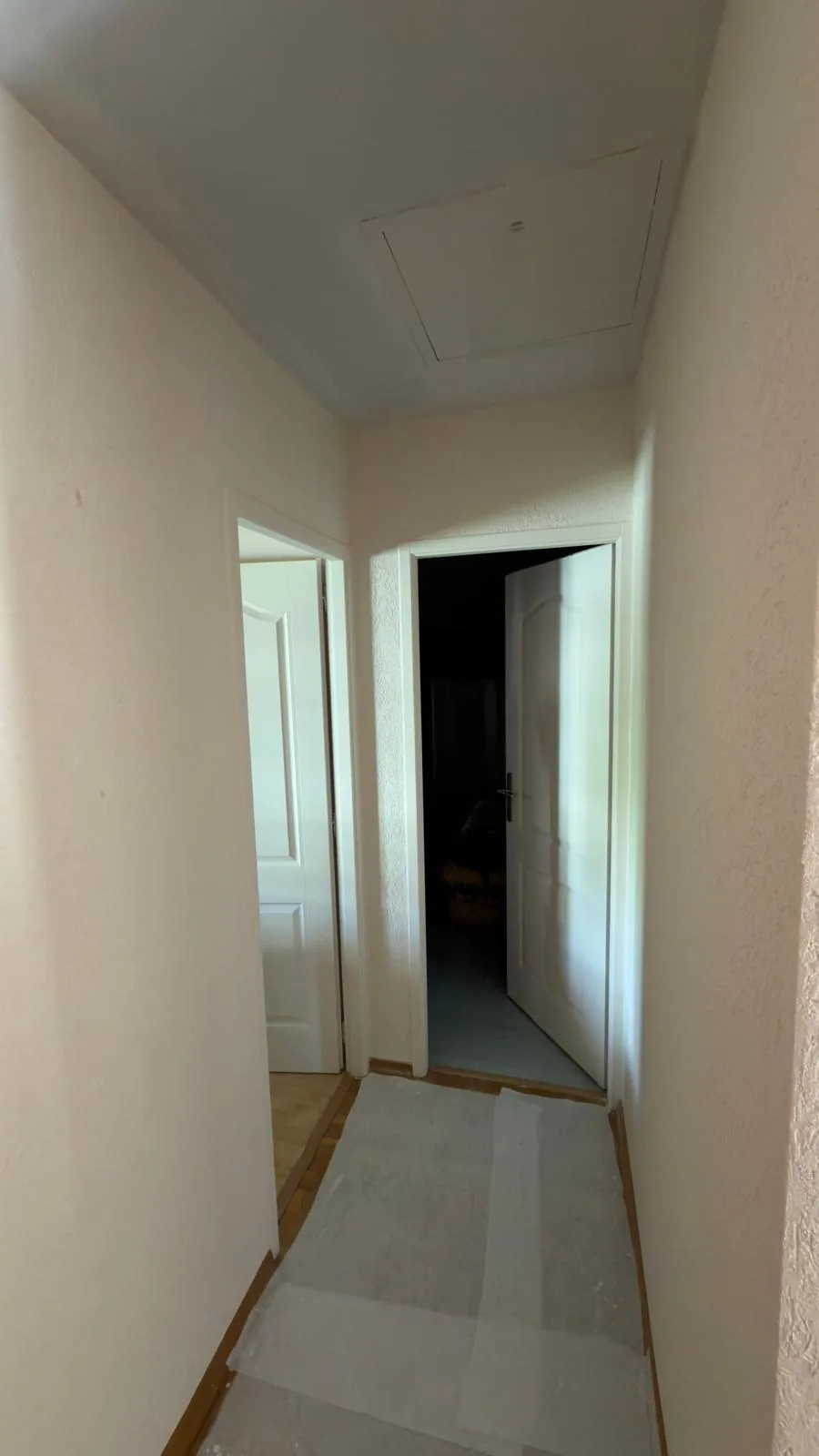 Murs clairs et plafond blanc dans un couloir.